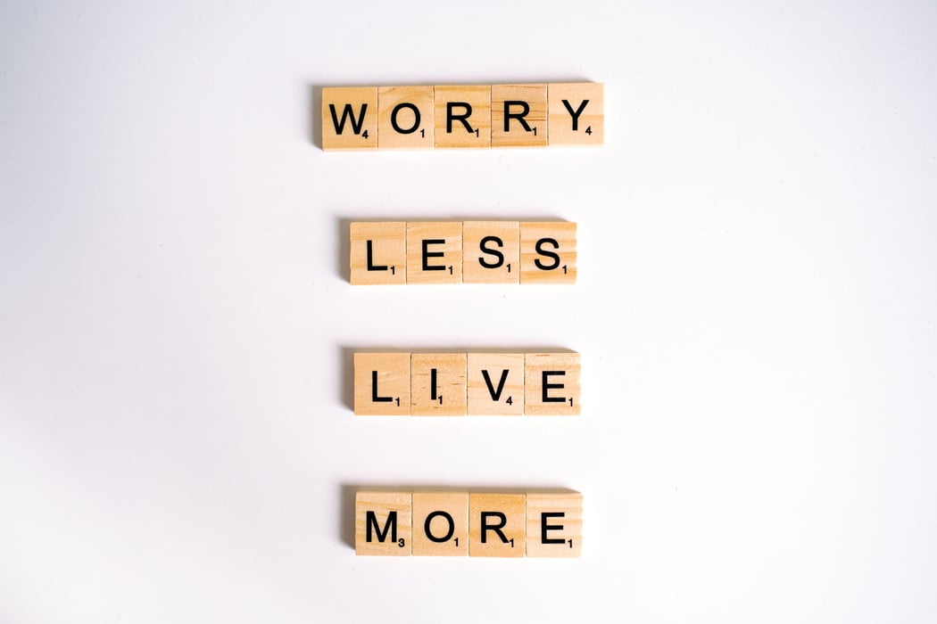 Close-Up Shot of Scrabble Tiles on a White Surface